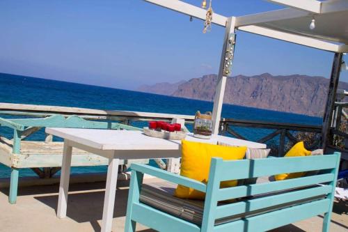 a table and chairs on the deck of a boat at VILLA AKTI in Mochlos