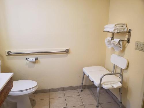 a bathroom with a toilet and a towel rack at Mission Inn San Luis Obispo in San Luis Obispo
