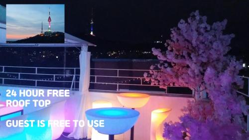 a purple tree on a balcony at night at Spring Light in Seoul