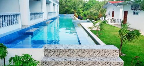 a swimming pool in the backyard of a house at Tablas Seaview Homestay in Ferrol