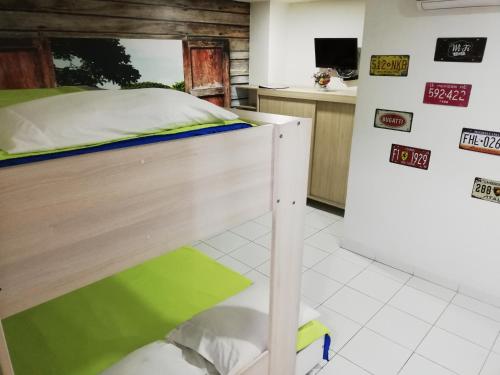 a bedroom with a bunk bed and a refrigerator at APARTA ESTUDIO 7051 in Medellín