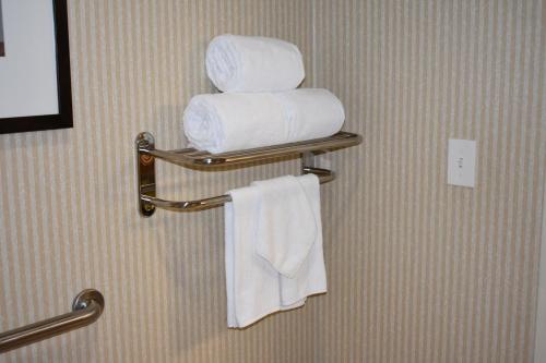 a bathroom with white towels on a towel rack at Studio 6 Carlsbad CA in Carlsbad