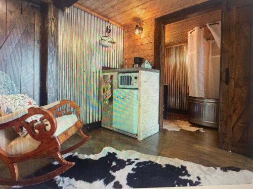 a kitchen with an old refrigerator and a chair at Z Ranch in Templeton