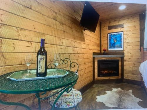 a bottle of wine on a table in a room with a fireplace at Z Ranch in Templeton