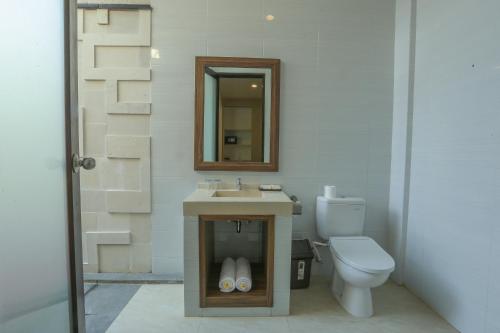 a bathroom with a sink and a toilet at Argya Santi Resort in Jimbaran