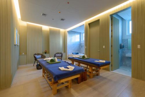 a waiting room with two tables and a bathroom at Aqua Boracay in Boracay