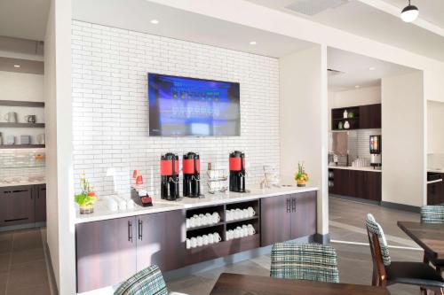 a dining room with a counter with wine bottles at Hyatt House East Moline/Quad Cities in East Moline