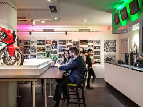 a group of people sitting at a bar at Mercure Dartford Brands Hatch Hotel & Spa in Ash