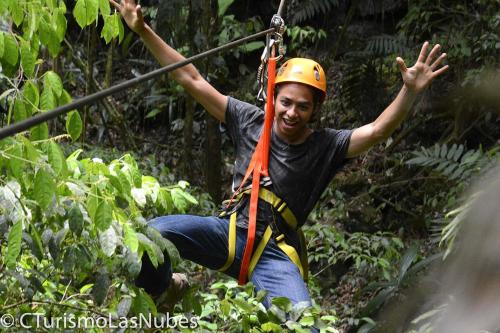 a man on a zip line in the jungle at Ciudad de Las Rocas in La Fortuna Gallo Giro