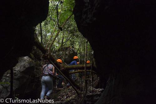 a group of people walking through a forest at Ciudad de Las Rocas in La Fortuna Gallo Giro