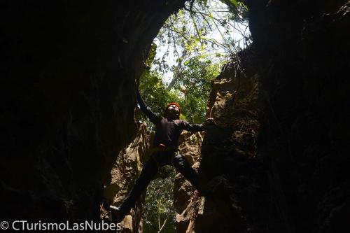 a person standing inside of a cave at Ciudad de Las Rocas in La Fortuna Gallo Giro