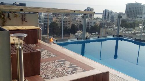 a swimming pool on the roof of a building at Aqua Royal Alexus Luxury Holiday Apartments Girne in Kérynia