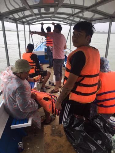 a group of people on a boat in the water at Ivory Falls Villa in Di Linh