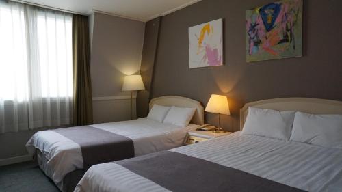 Postelja oz. postelje v sobi nastanitve Pearl Hotel Jeju