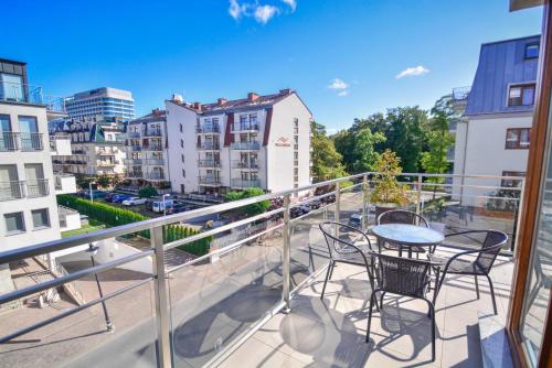 a balcony with a table and chairs on it at Apartamenty na Wyspie - Villa Pegaz - Parking in Świnoujście