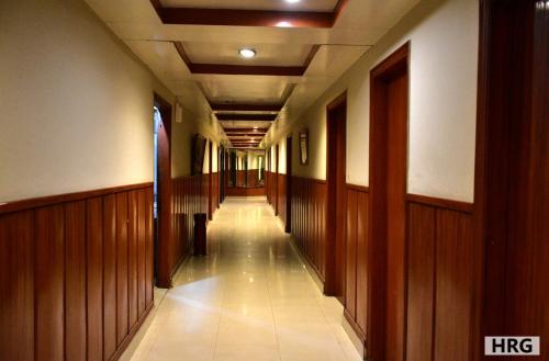 an empty hallway in a building with wood paneling at Hotel Royal Gardens Lahore in Lahore