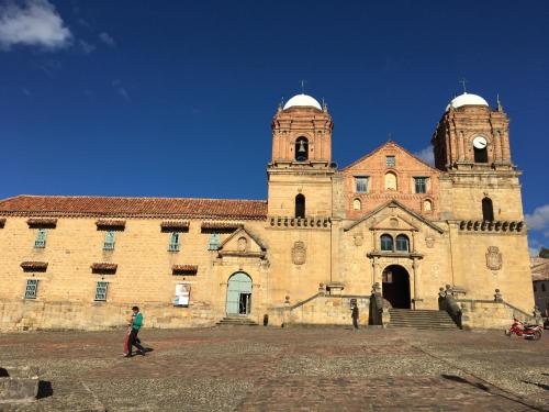 a large stone building with a clock tower at La Estancia de la Pradera Cabana Fiba in Nobsa