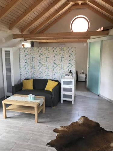 a living room with a couch and a table at ‘Feel So Good’ apartment in Göd