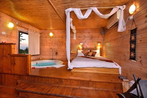 - une chambre avec un lit et une baignoire dans l'établissement Shangri-Hila Lodge, à Mitzpe Hila