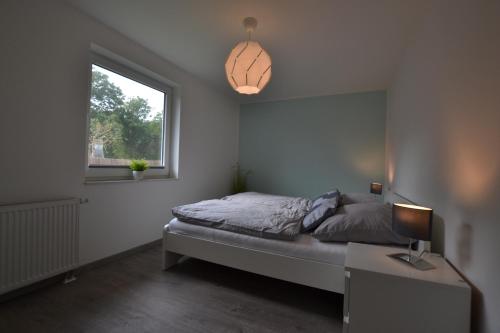 Кровать или кровати в номере Ferienhaus Gammendorf Nr. 18