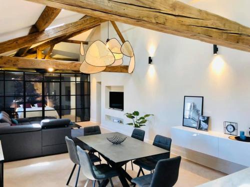 a dining room and living room with a table and chairs at Loft Chic in Carcassonne