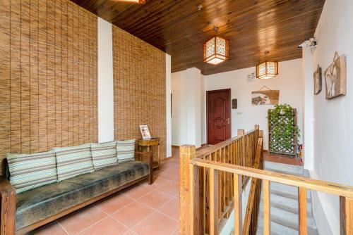 a living room with a couch and a staircase at Chaozhou Hello Inn in Chaozhou