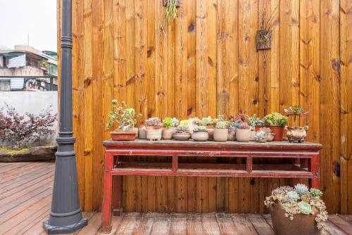 a wooden fence with potted plants on a table at Chaozhou Hello Inn in Chaozhou