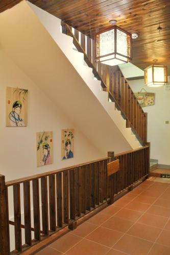a staircase in a building with paintings on the wall at Chaozhou Hello Inn in Chaozhou