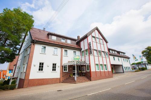 a large brick building with a clock on the side of the building at Hotel Waldhorn in Böblingen