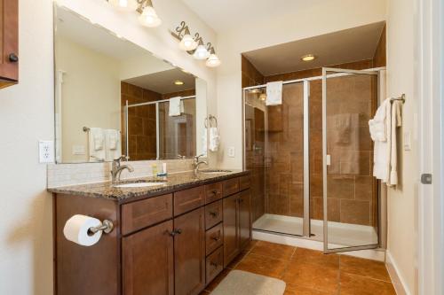a bathroom with two sinks and a shower at Beach Retreat in Galveston