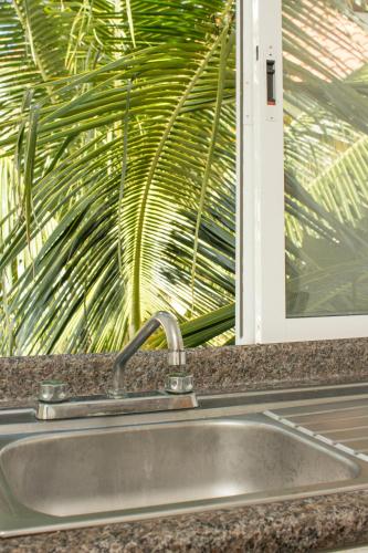 a sink in a kitchen with a window at Hotel Sol Playa in Playa del Carmen
