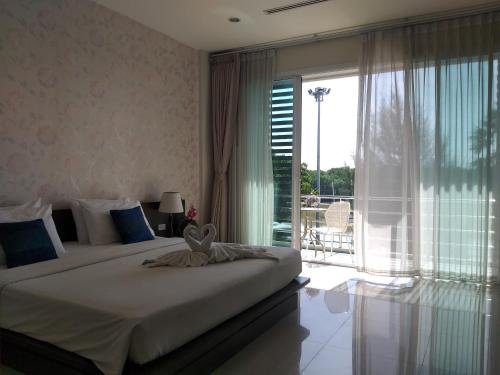 a bedroom with a large bed and a large window at Krabi River View Hotel in Krabi