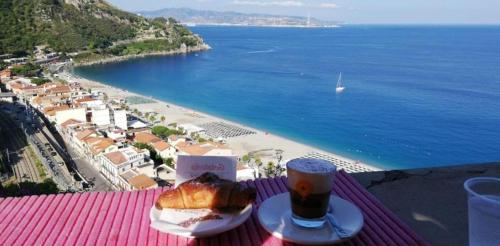 a table with a plate of food and a cup of coffee at Antico Vicolo in Scilla