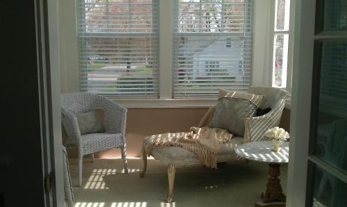 two chairs and a chair in a room with windows at Victoria Inn in Hampton