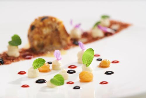 a close up of some food with plants on it at Rooms & Restaurant Ostarija in Dolenjske Toplice