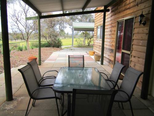 una mesa con sillas y un ordenador portátil en el patio en Lavendale Country Retreat, en York