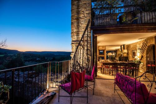 a patio with chairs and a table on a balcony at Chambre et Gite Le Roc sur l'Orbieu in Saint-Pierre-des-Champs