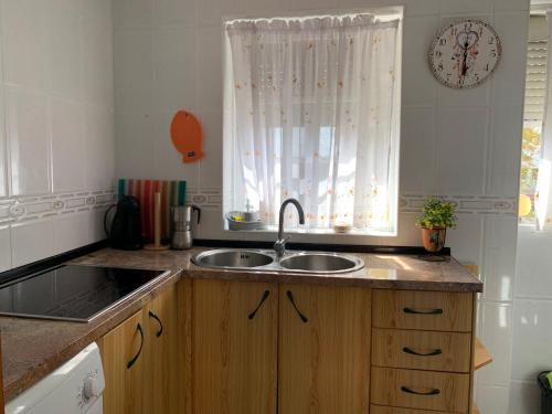a kitchen with a sink and a window at Calle cómico Riquelme 23 segundo in Málaga