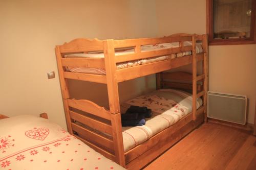 two bunk beds in a room with a bed at At Home in Les Carroz d'Araches
