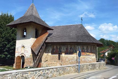 a building with a tower on the side of a street at LA LIVADA in Valea Danului
