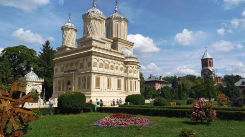 a large building with domes on top of a garden at LA LIVADA in Valea Danului