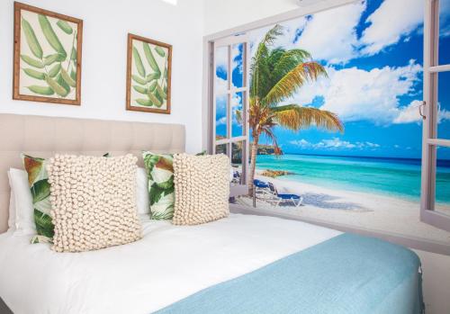 a bedroom with a view of the beach at Palm Cottage in Durban