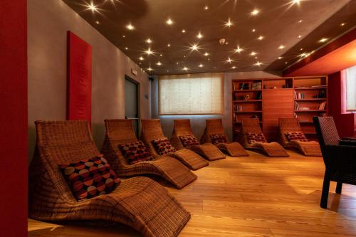 a waiting room with chairs and lights on the ceiling at Hotel Isolabella Wellness in Fiera di Primiero