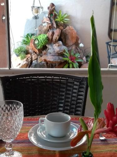 a table with a cup and a plate on a table at Terrazzo Suites in Capitólio