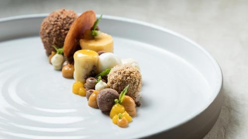 a white plate of food on a table at Das Homann in Samnaun