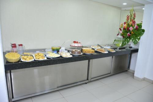 a buffet line with many different types of desserts at Goiana Palace Hotel - Fácil Acesso a Fábrica da JEEP in Goiana