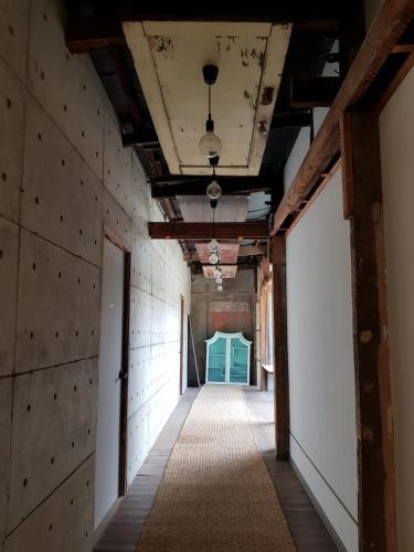 an empty hallway in an old building with blue doors at Eia by Dawata in Cebu City