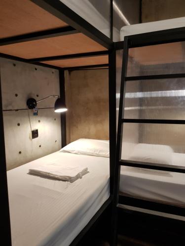 a bedroom with a bunk bed with a ladder at Eia by Dawata in Cebu City