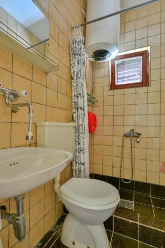 a bathroom with a toilet and a sink at Baka Zlata Apartments in Petrovac na Moru