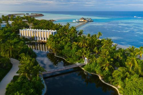 an aerial view of a beach with palm trees and the ocean at Pullman Maldives Maamutaa - All-Inclusive Resort - 50 percent off Transfers in Maamutaa